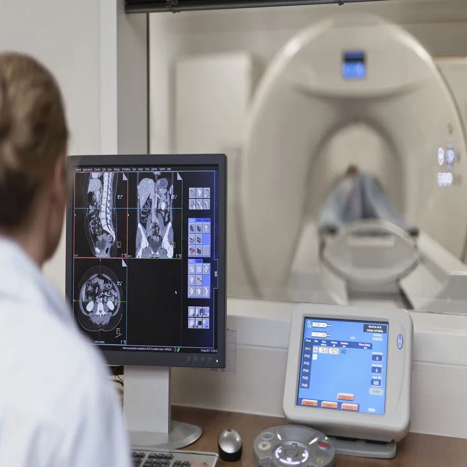 CT scan radiologist at workstation